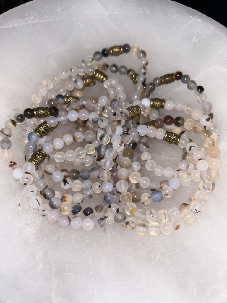 Pile of Flower Agate Bracelets on a Tray