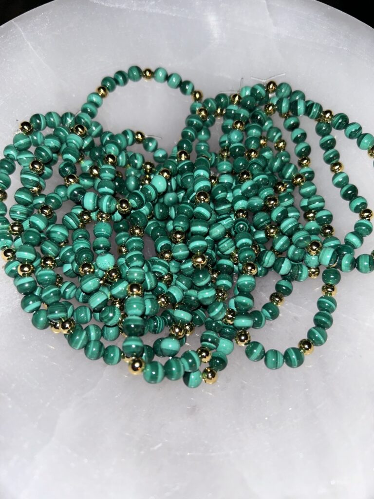 Bundle of Malachite Gold Bracelets on Marble