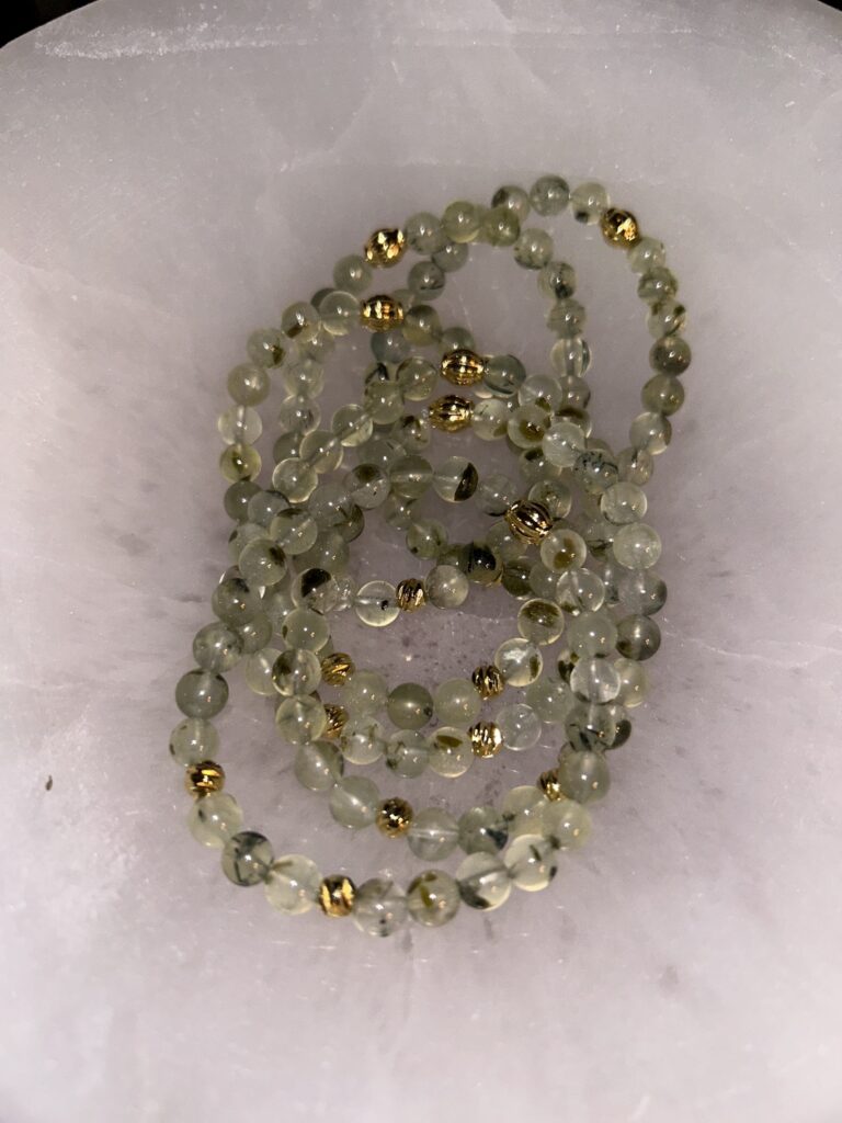 Pile of Prehnite Bracelets on Marble