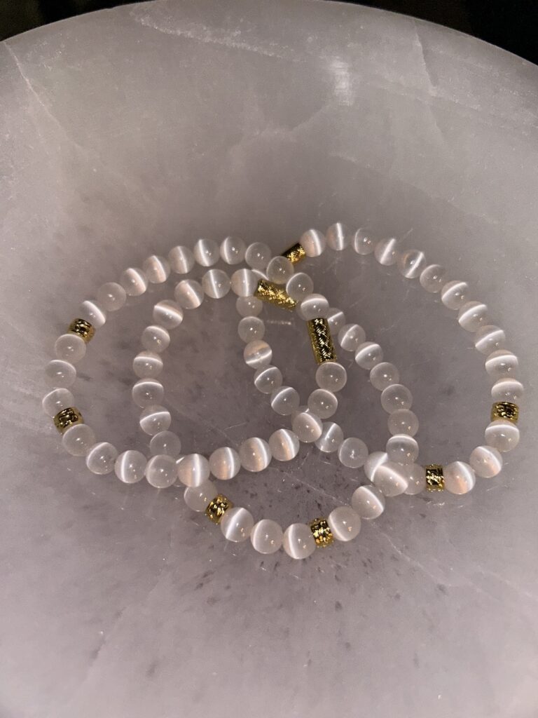 Three Selenite Gold Bracelets on Marble