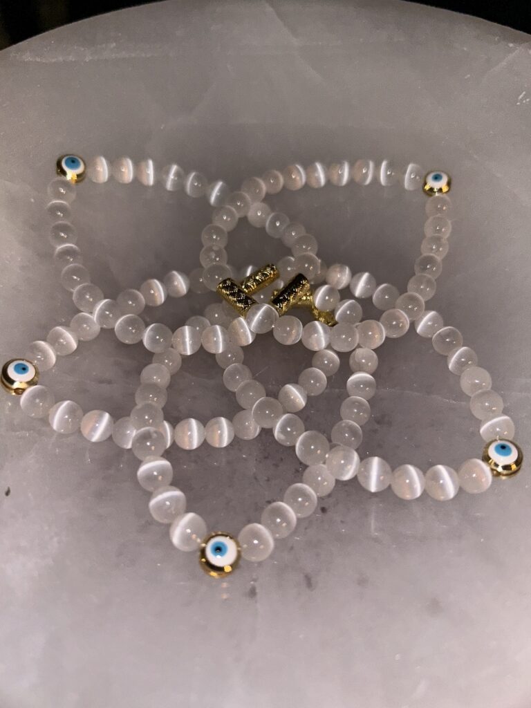 5 Petal Flower of Selenite with Evil Eye Bracelets on Marble