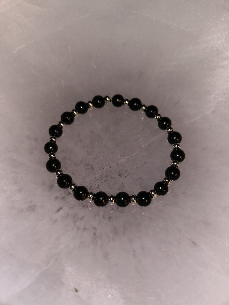 Single Black Shungite Bracelet on dark marble